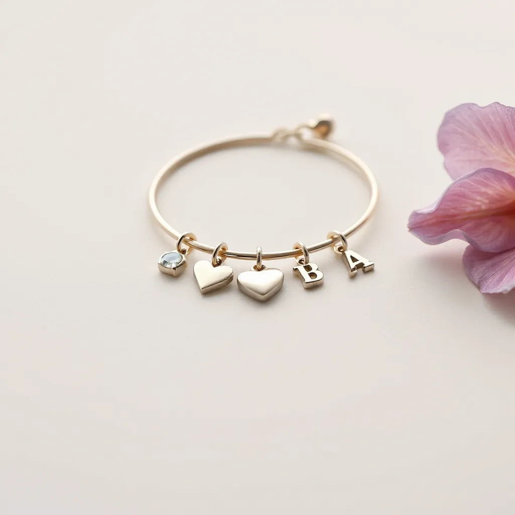 Charm bracelet with assorted meaningful charms and a small gemstone on a neutral background