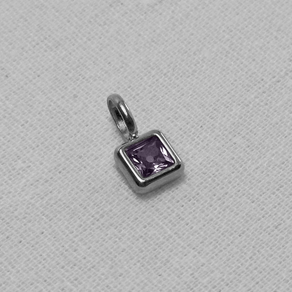 Green birthstone pendant on a white background