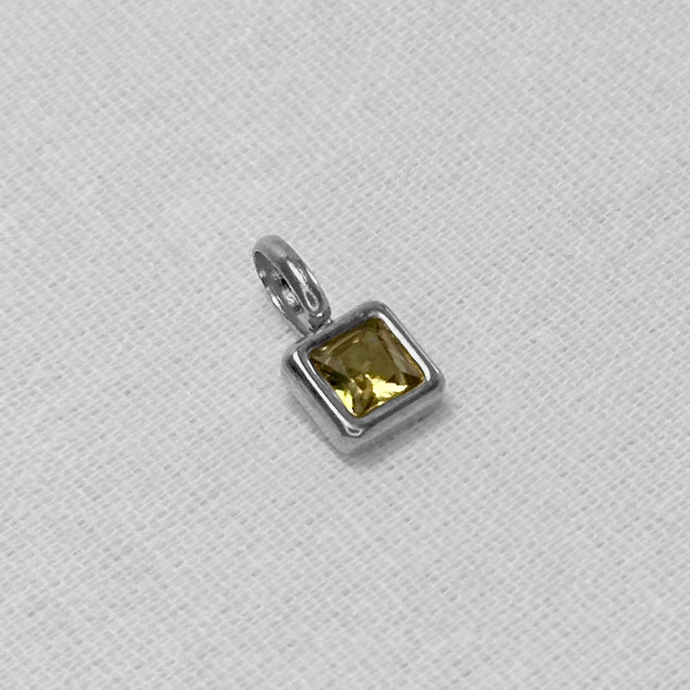 orange birthstone in silver shown on a plain white background.