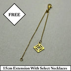 15cm gold necklace extension chain with lobster clasp and diamond-shaped charm on fabric background