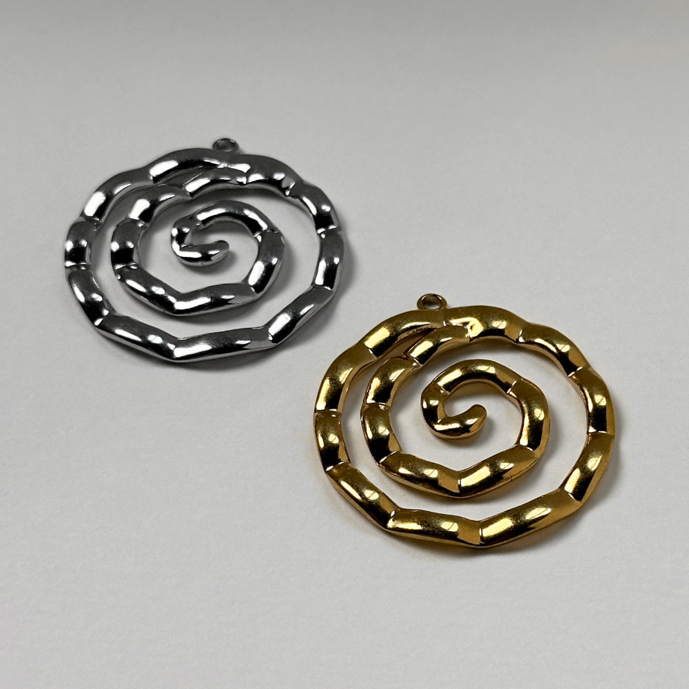 Two spiral-shaped metal jewelry charms, one in polished silver and one in polished gold, displayed on a neutral light gray background.