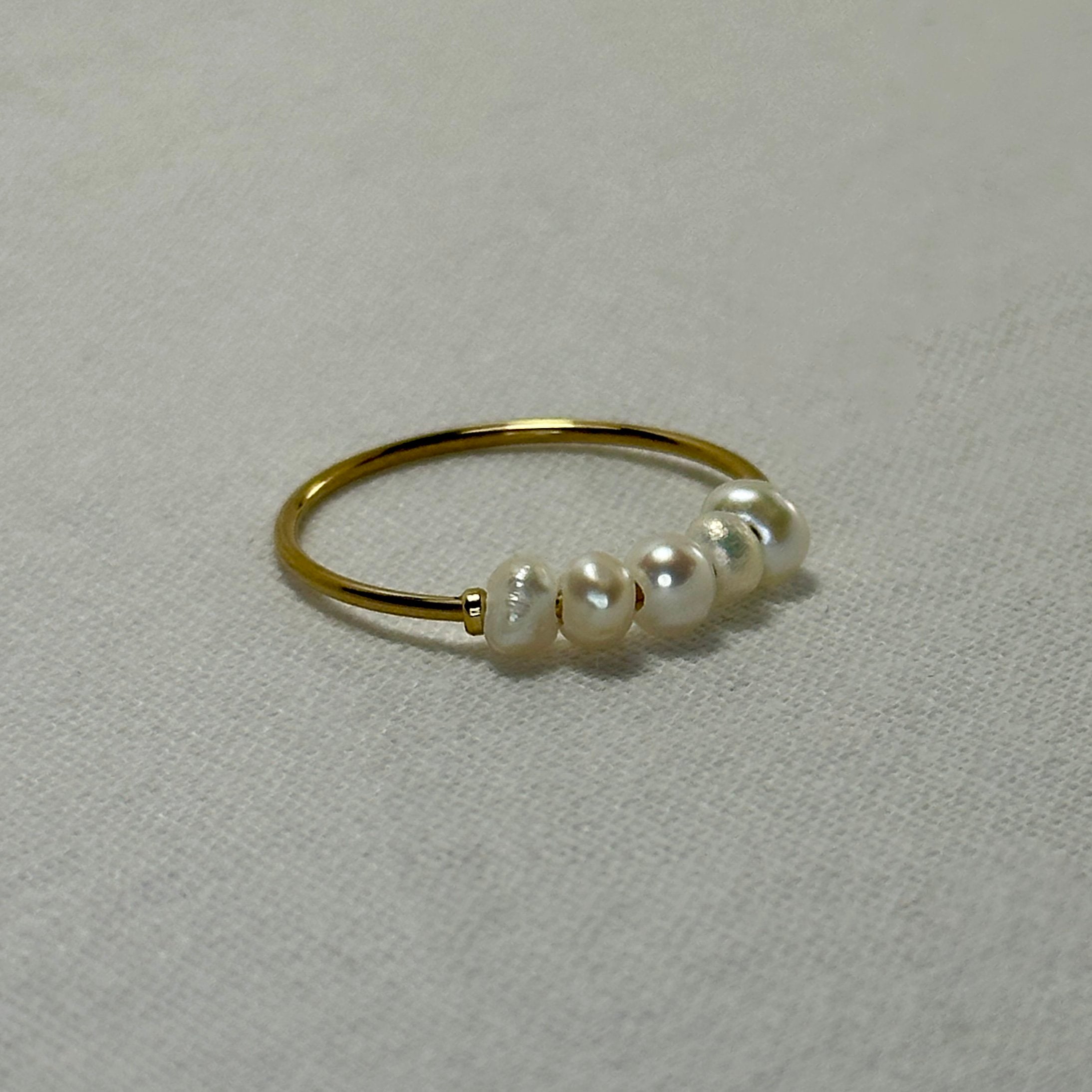Gold ring with five pearls.
