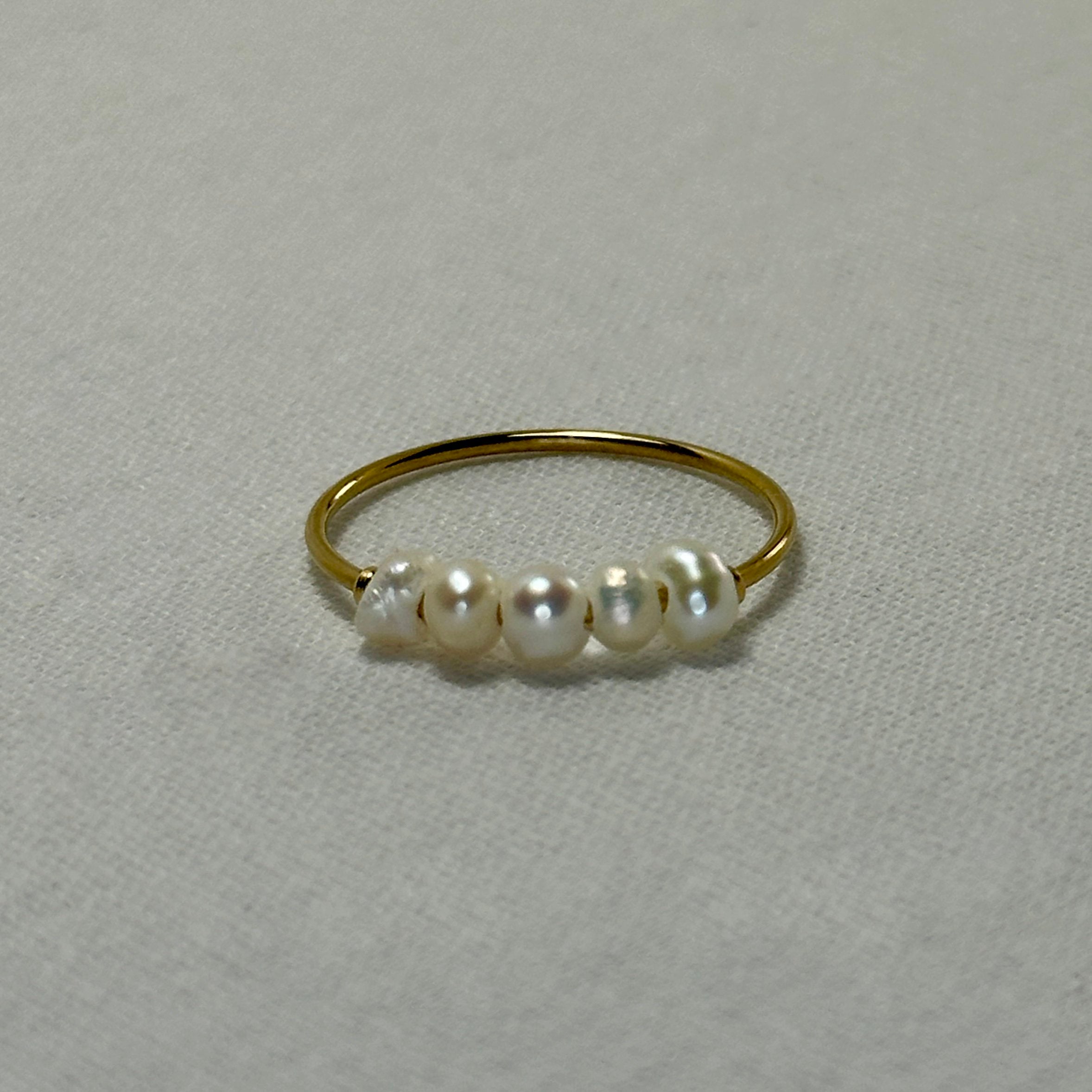 Gold ring with five pearls.
