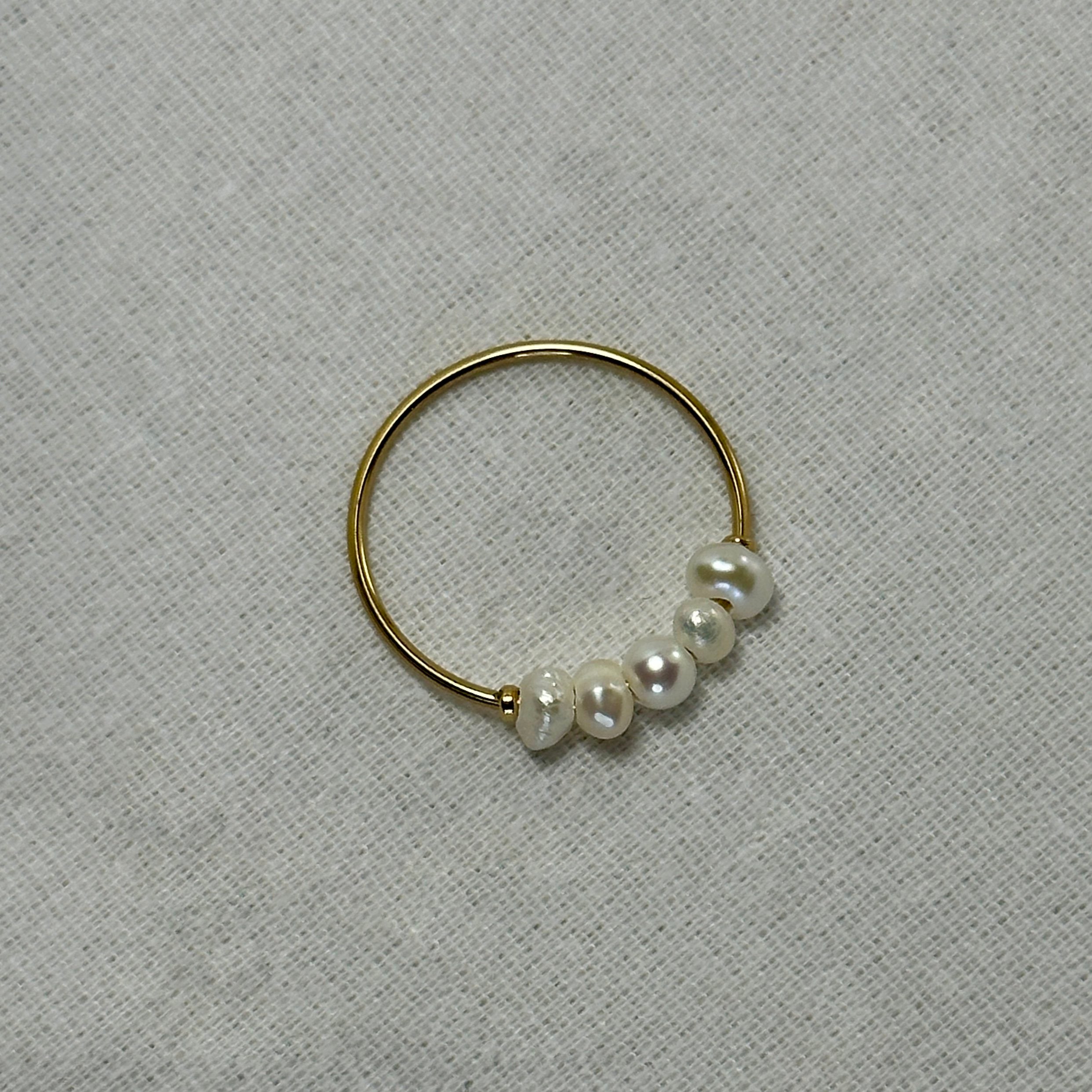 Gold ring with five pearls.
