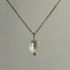 Elegant gold chain necklace with a single white pearl pendant and small gold bead