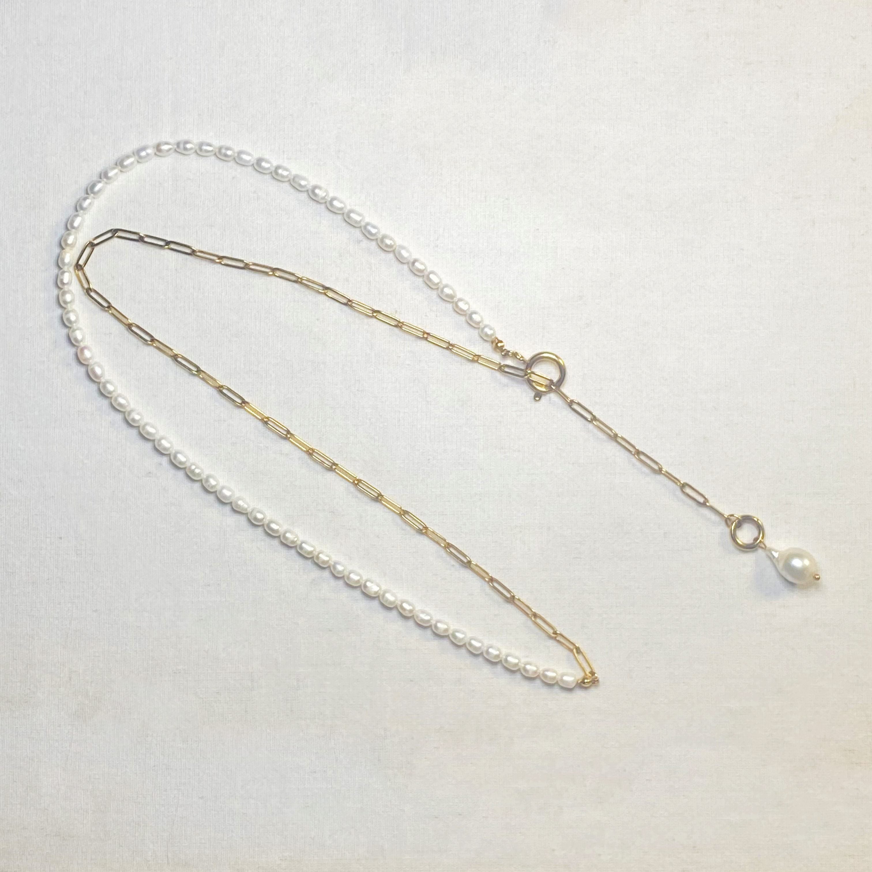 Necklace with pearls on a light gray background and lumenaura jewellery 