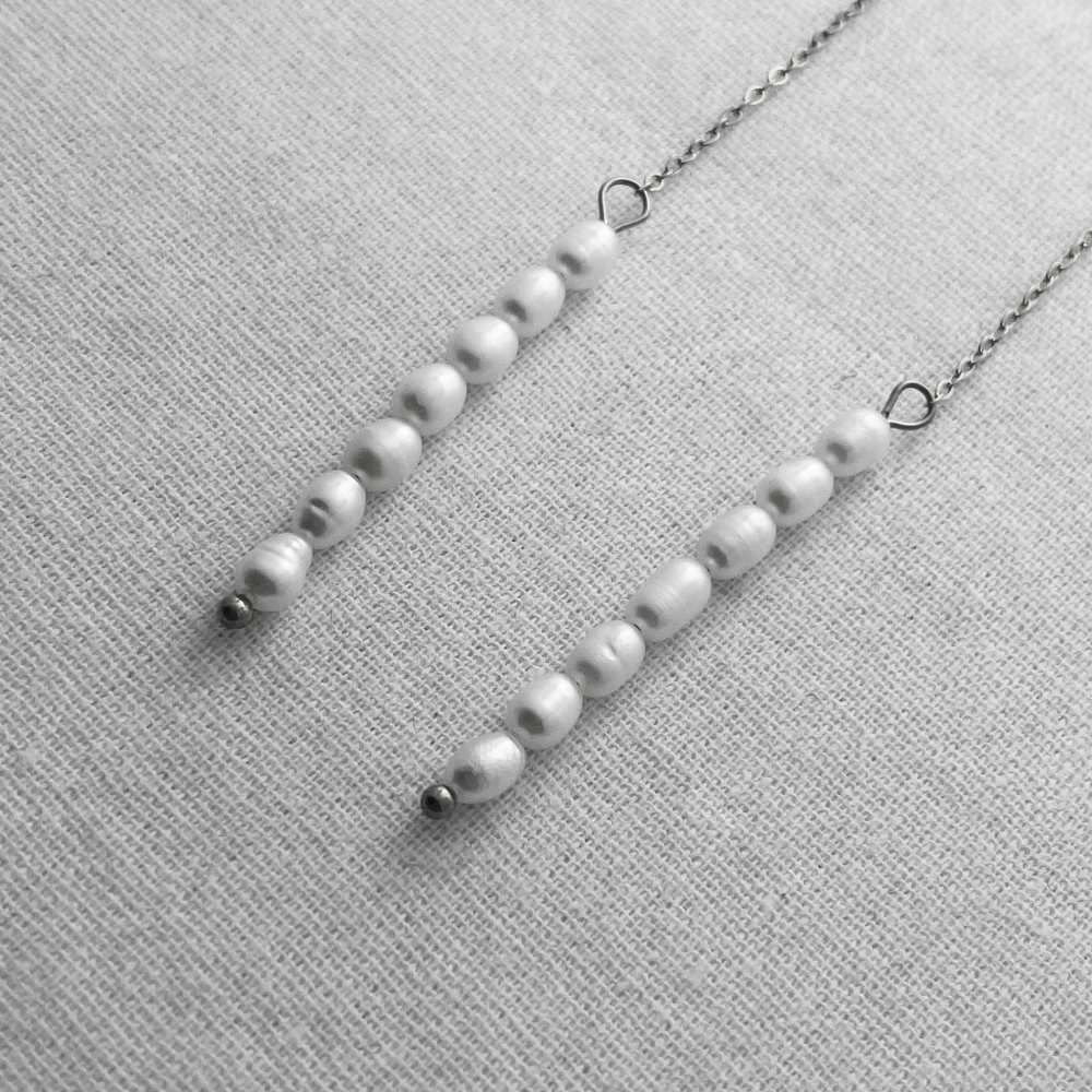 Pearl necklace on a textured gray surface